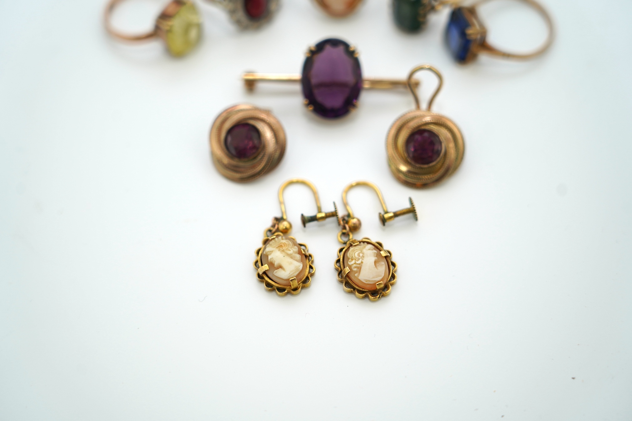 Five assorted 9ct and gem set rings, including cameo shell, two pairs of ear clips including 9ct cameo shall with rolled gold clip and a yellow metal and gem set bar brooch. Condition - poor